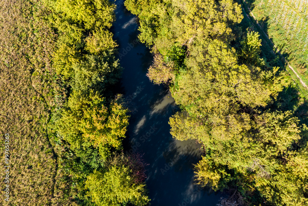 Aerial view of a river bed with overgrown banks Aerial view of a river bed with overgrown banks