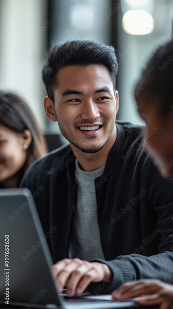 Young asian male teacher and diverse students gather around a laptop in the classroom Young asian male teacher and diverse students gather around a laptop in the classroom