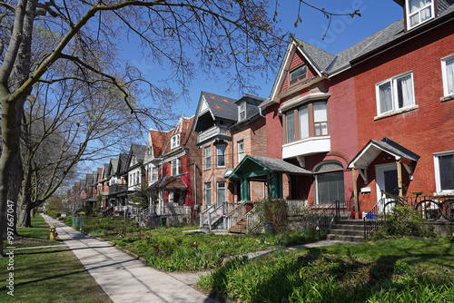 Canvas Print Residential street with long row of older houses with gables