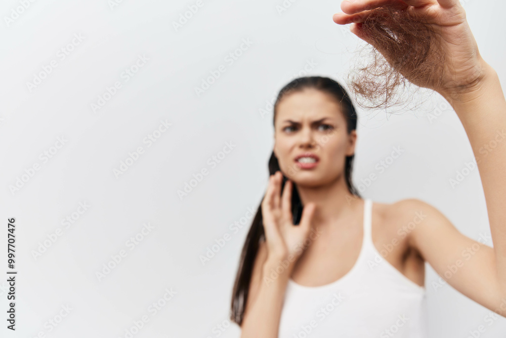 Hair loss, concern, anxiety, young woman, unhealthy hair, white background, personal care, self esteem issues, hair health, beauty routine Hair loss, concern, anxiety, young woman, unhealthy hair, white background, personal care, self esteem issues, hair health, beauty routine