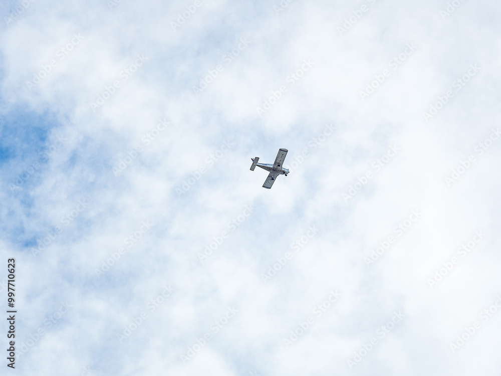 Small ultralight airplane with overhead wing and single propeller flying in sunset sky. Small ultralight airplane with overhead wing and single propeller flying in sunset sky.