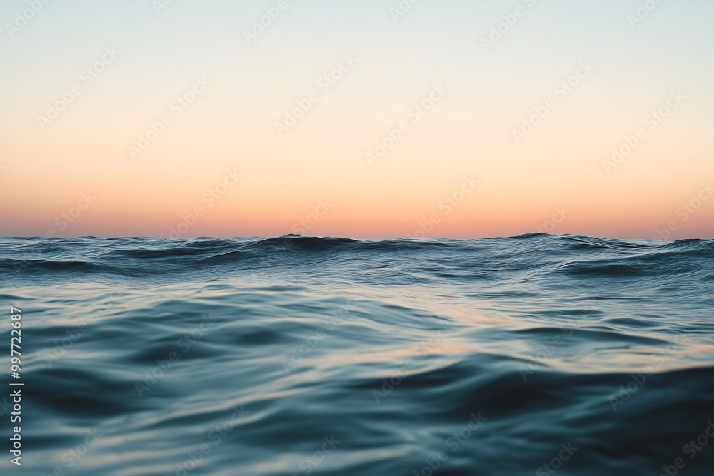 Obraz premium Serene Sunset Over Calm Ocean Waves