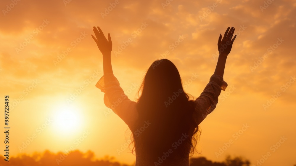Silhouette of a woman with raised hands in prayer, bathed in the golden glow of a sunrise, exuding a sense of spirituality and tranquility. Silhouette of a woman with raised hands in prayer, bathed in the golden glow of a sunrise, exuding a sense of spirituality and tranquility.