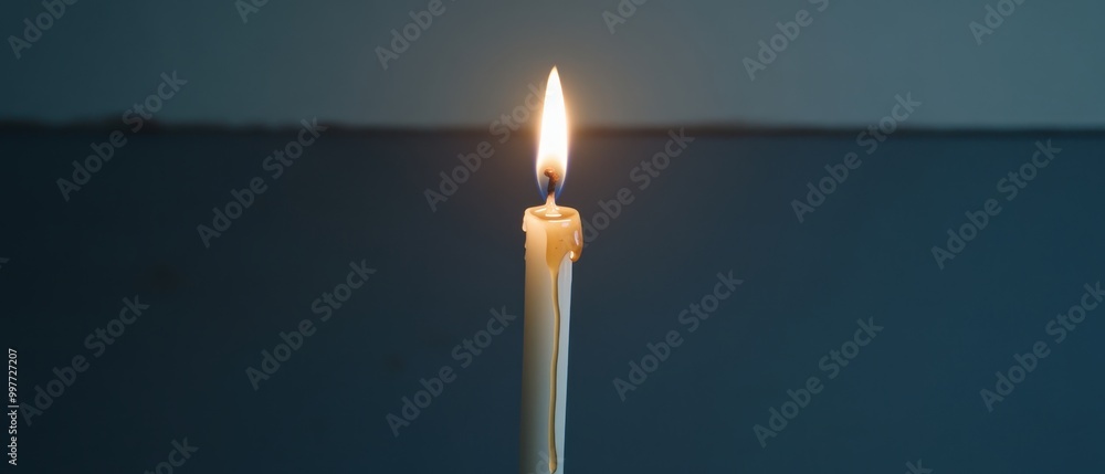 A solitary candle burns brightly against a dark background, casting a warm glow that creates a serene and peaceful atmosphere. A solitary candle burns brightly against a dark background, casting a warm glow that creates a serene and peaceful atmosphere.