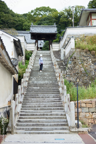 お寺への階段を登る旅行中の日本人女性