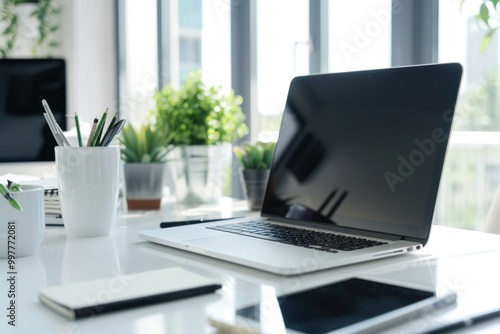 Wallpaper Mural Minimalist office workspace with laptop, plants, and stationery on a bright desk. Clean and modern design. Torontodigital.ca