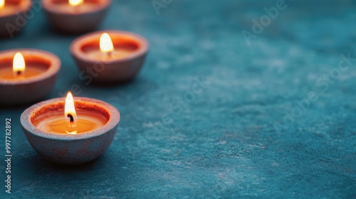 Warm glow of traditional candles on a textured surface