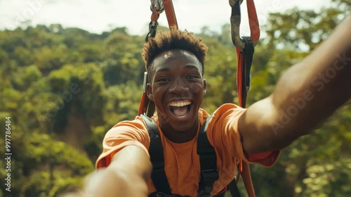 Joyful Young Man Ziplining Through Lush Landscape photo