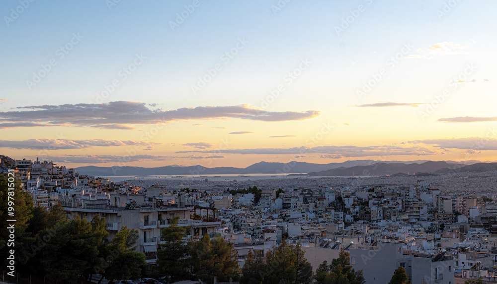 View of the Athens city and the port of Piraeus from a hill during dusk time. Nice dramatic sky. View of the Athens city and the port of Piraeus from a hill during dusk time. Nice dramatic sky.