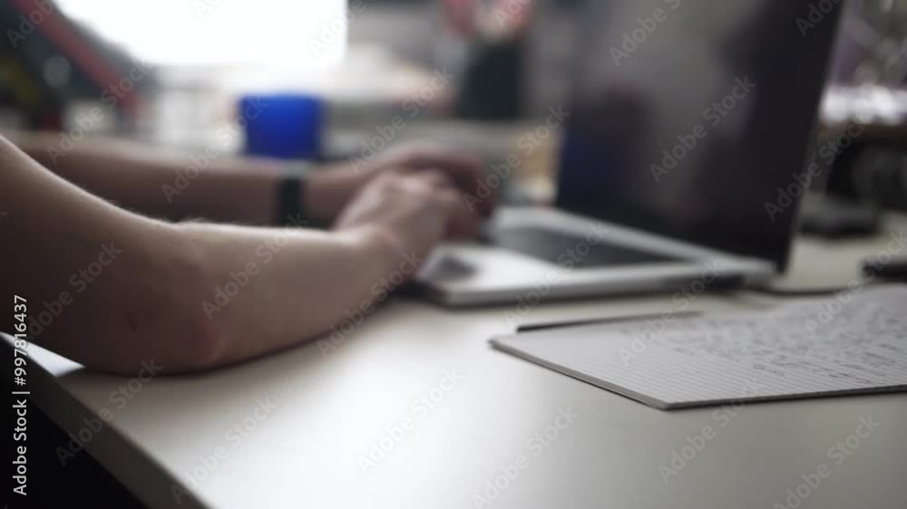 Man Writing Ideas While Working on Laptop Man Writing Ideas While Working on Laptop