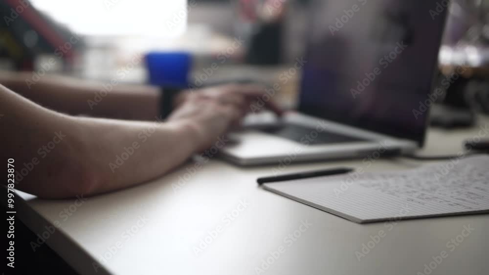 Man Writing Ideas While Working on Laptop Man Writing Ideas While Working on Laptop