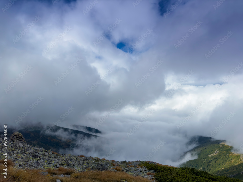 Early autumn scenery in the Transylvanian Alps with mist and storm clouds Early autumn scenery in the Transylvanian Alps with mist and storm clouds