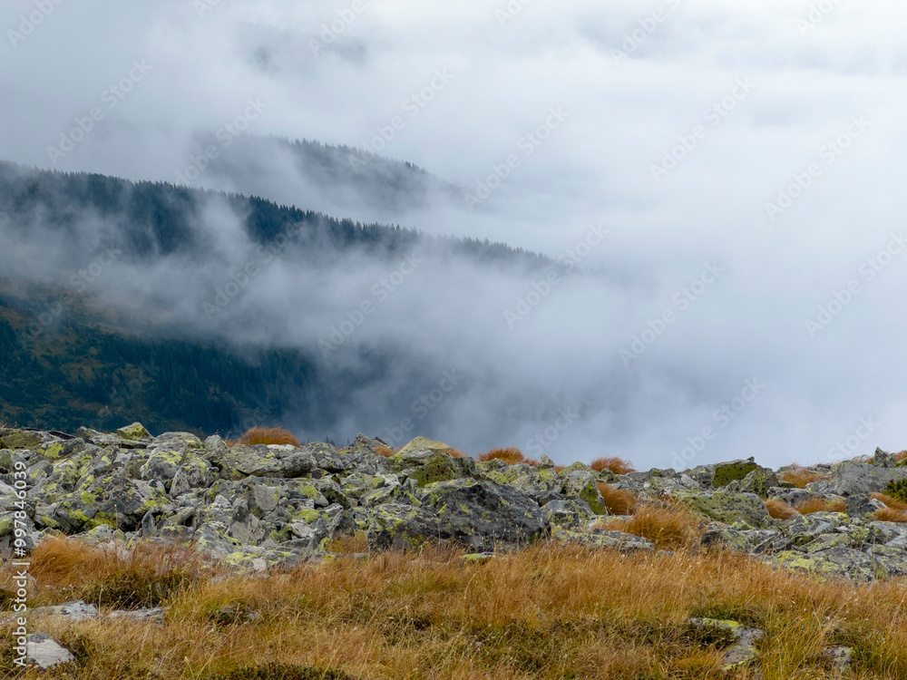 Early autumn scenery in the Transylvanian Alps with mist and storm clouds Early autumn scenery in the Transylvanian Alps with mist and storm clouds