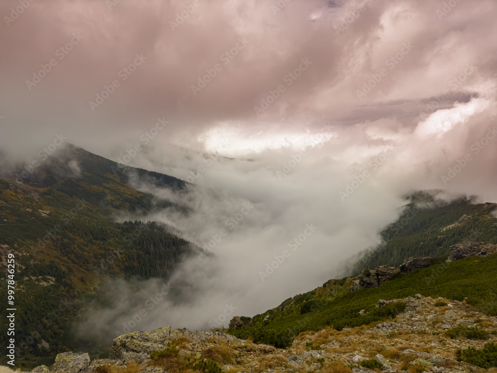 Early autumn scenery in the Transylvanian Alps with mist and storm clouds Early autumn scenery in the Transylvanian Alps with mist and storm clouds