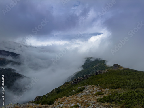 Early autumn scenery in the Transylvanian Alps with mist and storm clouds