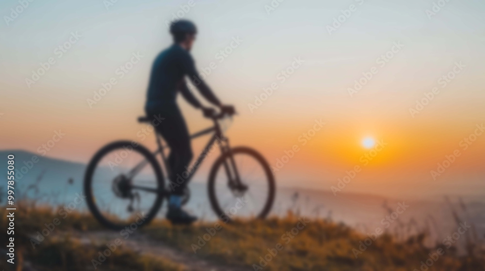 Cyclist's Silhouette Blurred on a Mountain Trail, Surrounded by the Warm Sunrise Cyclist's Silhouette Blurred on a Mountain Trail, Surrounded by the Warm Sunrise