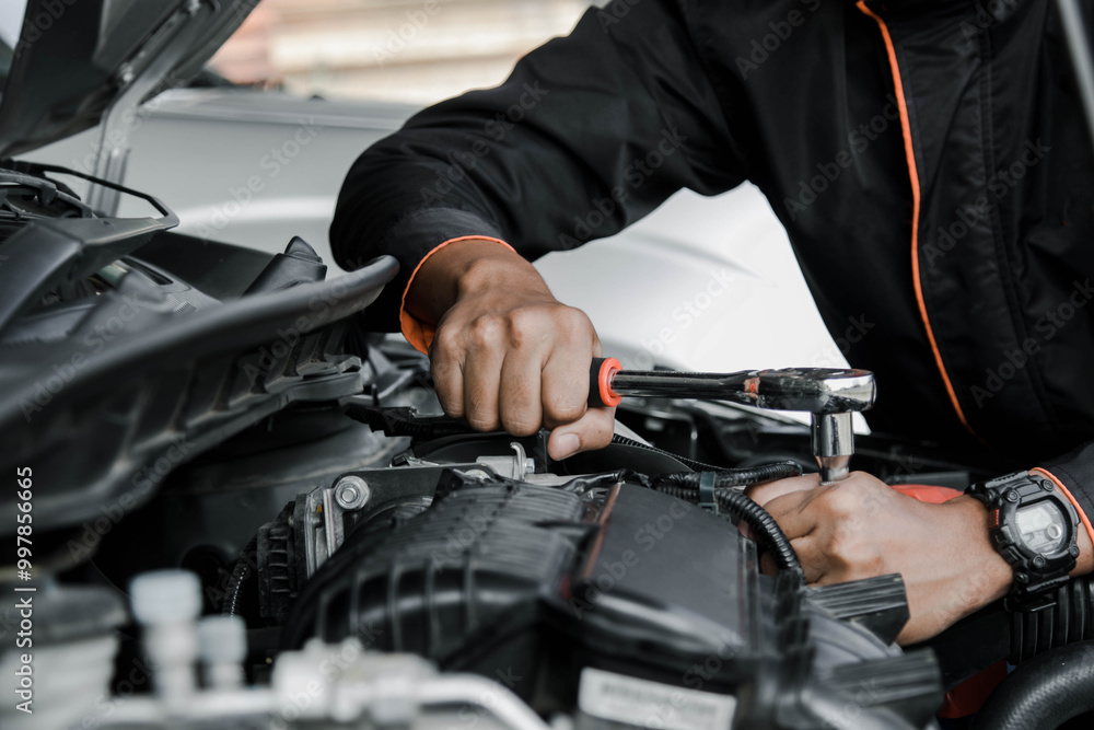 Mechanic fixing a car at home. Repair and service. Mechanic fixing a car at home. Repair and service.