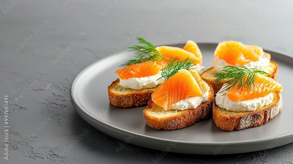 Delicate smoked salmon bites with cream cheese on toast, garnished with dill, appetizers Delicate smoked salmon bites with cream cheese on toast, garnished with dill, appetizers