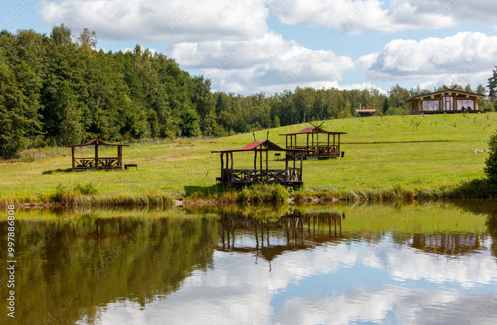 Obraz premium A peaceful scene of a lake with a few wooden structures