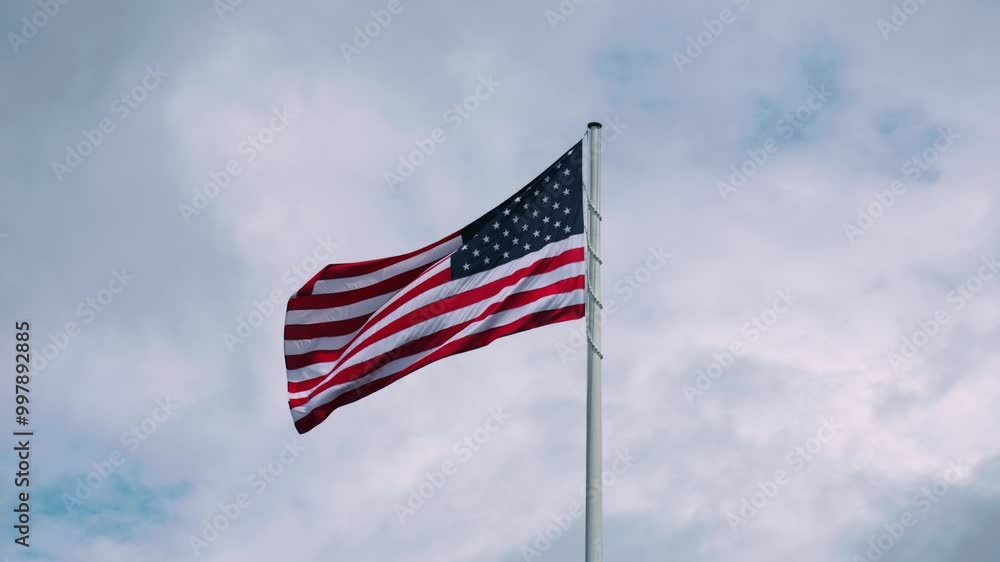 Patriotic waving american flag in overcast cloudy day Patriotic waving american flag in overcast cloudy day