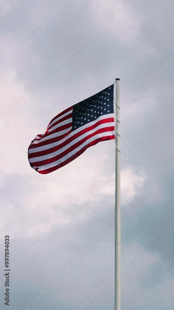 Patriotic waving american flag in overcast cloudy day Patriotic waving american flag in overcast cloudy day