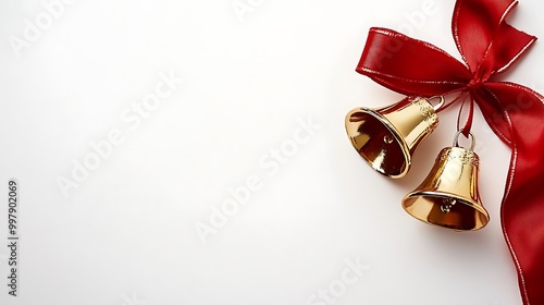 Christmas bells tied with a ribbon on a blank white page