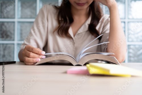 Young woman reading a book with music.