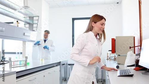 Wallpaper Mural Young female scientist working at the lab on examining some samples Torontodigital.ca