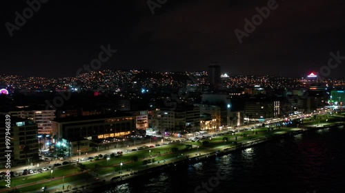 Wallpaper Mural Night view of the city of izmir, buildings by the sea and people on the beach. drone shot along the promenade in izmir Torontodigital.ca