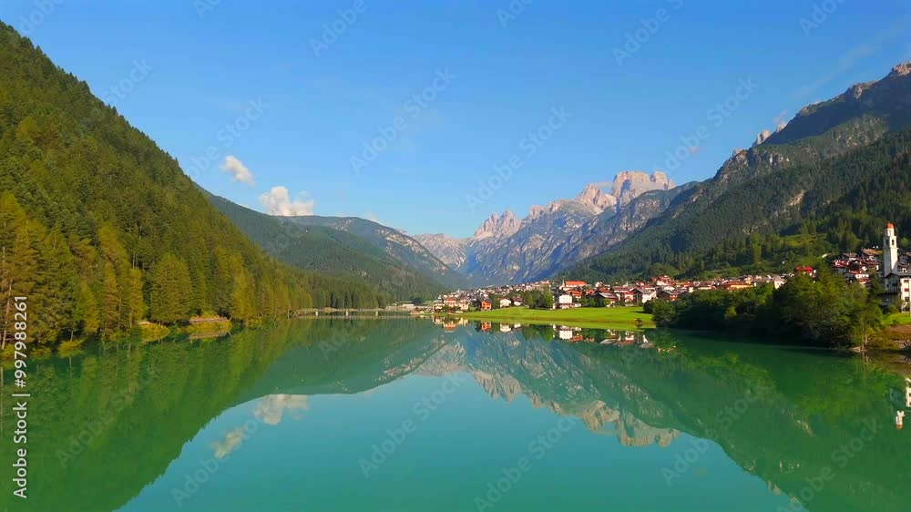 Experience the serene charm of Lake Auronzo as the drone glides over its tranquil surface, revealing the vibrant colors and reflections of the surrounding scenery. Experience the serene charm of Lake Auronzo as the drone glides over its tranquil surface, revealing the vibrant colors and reflections of the surrounding scenery.