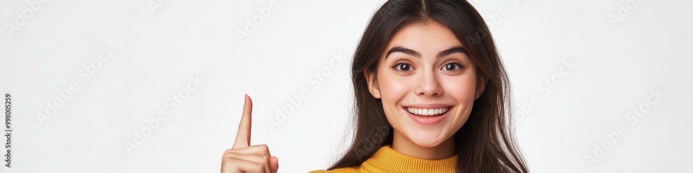 Young woman pointing finger up, excited idea, happy smile, inspiration Young woman pointing finger up, excited idea, happy smile, inspiration