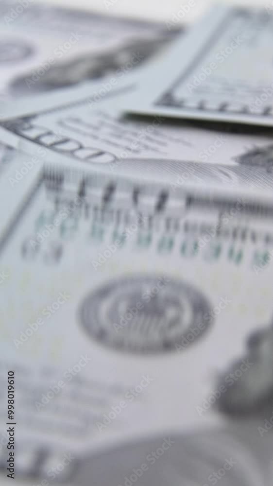 Vertical video. American cash dollars close up. A large amount of cash American dollars in cash paper bills.