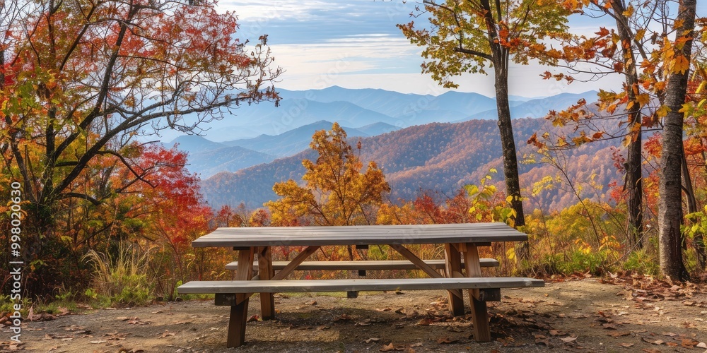Natural wood picnic table set amidst colorful autumn trees, with mountains in the background. Natural wood picnic table set amidst colorful autumn trees, with mountains in the background.
