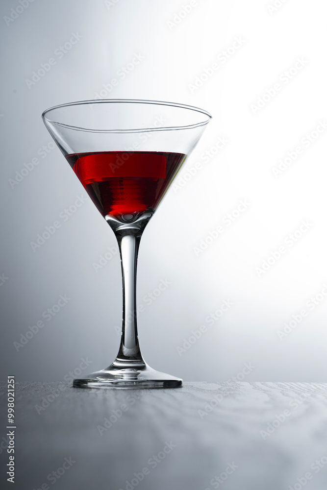wine in a glass isolated on wooden table with white background wine in a glass isolated on wooden table with white background