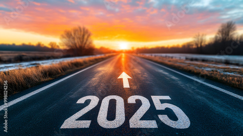 A road leading towards a bright sunset with 2025 marked on the asphalt. Generative AI