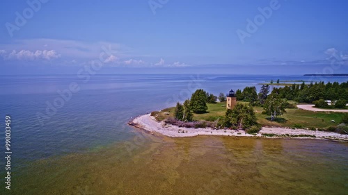 Drone shot panning flying right to left to reveal the lighthouse on the stonington peninsula in the U.P. of Michigan on beautiful summer day photo