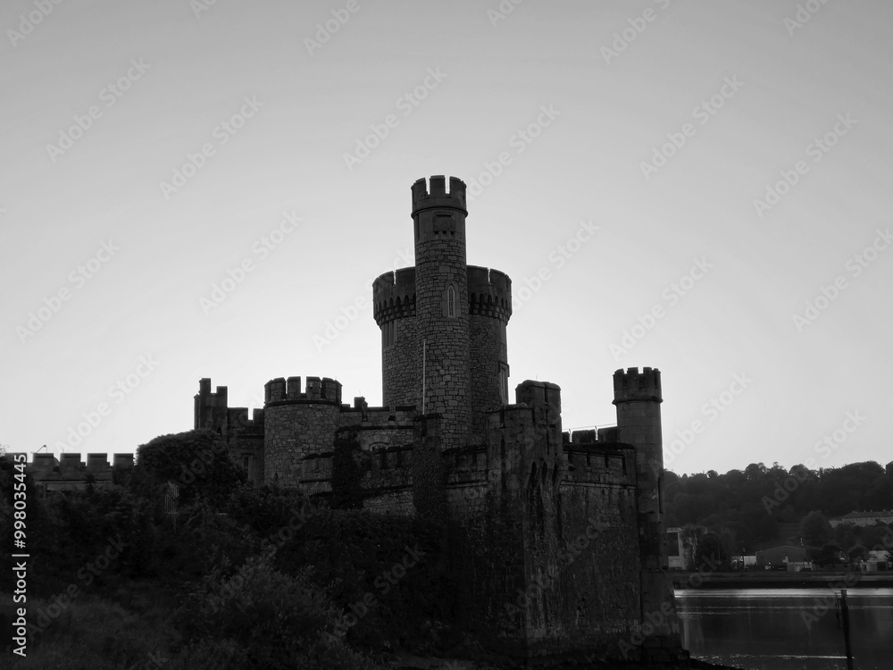 Fototapeta premium Blackrock castle observatory silhouette in the rays of sunset sun black and white monochrome background