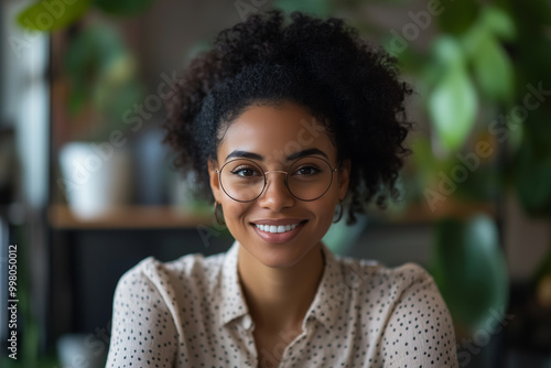 African American woman working remotely during a team meeting call, representing a flexible DEI work culture. photo