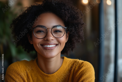 African American woman working remotely during a team meeting call, representing a flexible DEI work culture. photo