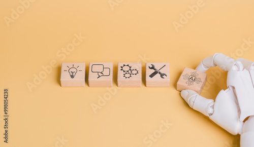 Obraz na płótnie Robot hand holding AI icon, concept of working and helping humans to develop business and create new things, prompting command to create something, future technology w salonie