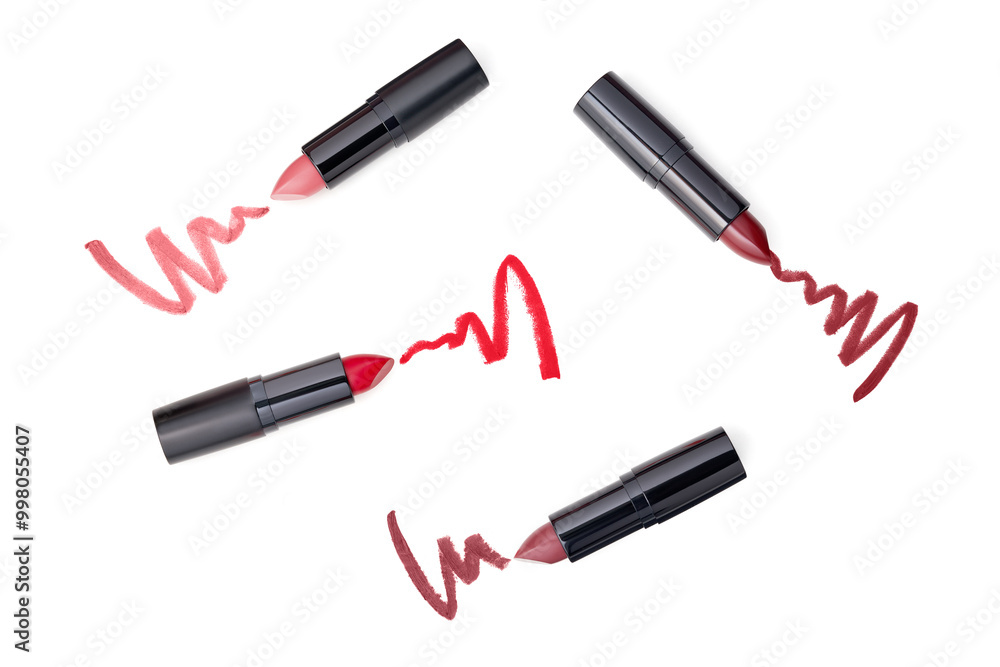 Set of lipsticks and lipstick smears isolated on white background. Beauty and cosmetics background. Set of lipsticks and lipstick smears isolated on white background. Beauty and cosmetics background.