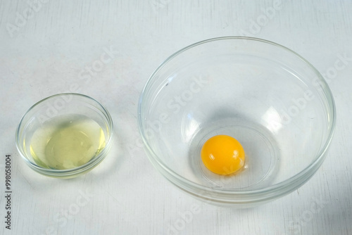 cooking separates the white from the yolk to prepare dish, bake at home. Recipe, use ingredients at home. Cooking sauce dressing for salad, homemade mayonnaise meat dishes. Culinary cuisine.