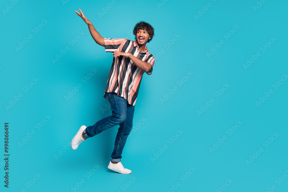 Fototapeta premium Full size photo of nice young man dancing wear shirt isolated on teal color background