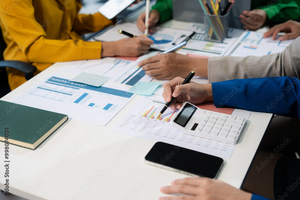 financial asian advisor showing plan of investment to clients in the consultancy office. financial asian advisor showing plan of investment to clients in the consultancy office.