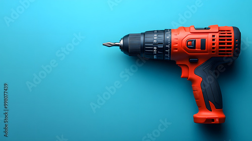 Sleek Red Power Drill on a Blue Background in a Flat Lay 