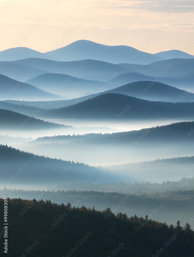 Fototapeta premium A misty morning over rolling hills creates a layered, abstract landscape with subtle color variations.
