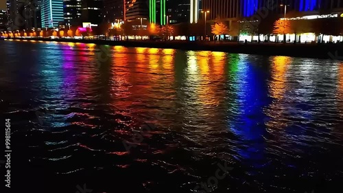 Cityscape at Night with Colorful Reflections on Water