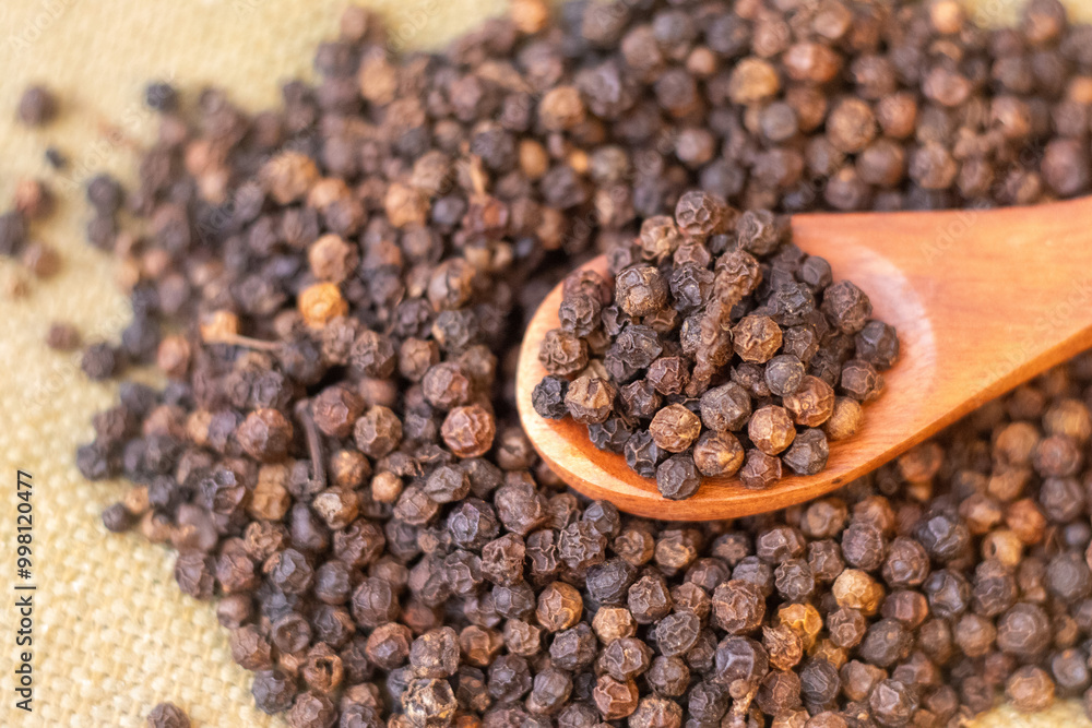black pepper Indian spice on a brown background black pepper Indian spice on a brown background