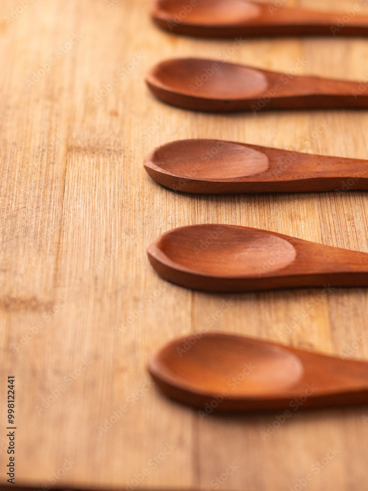 vertical picture and close up of 5 wooden spoons kept on a wooden table, empty spoons restaurant spoons vertical picture and close up of 5 wooden spoons kept on a wooden table, empty spoons restaurant spoons
