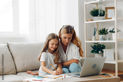 Mother and daughter bonding on the couch while exploring new adventures online with a laptop in a cozy home setting